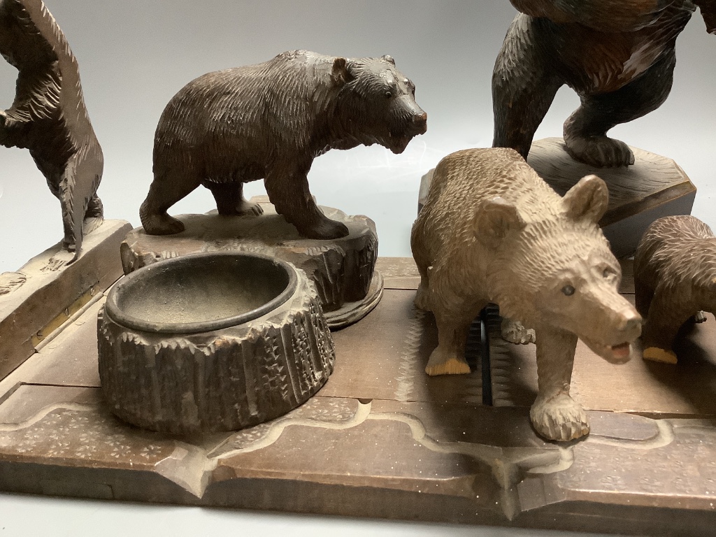 A collection of Black Forest carvings - a bookslide, an ashtray and four bears